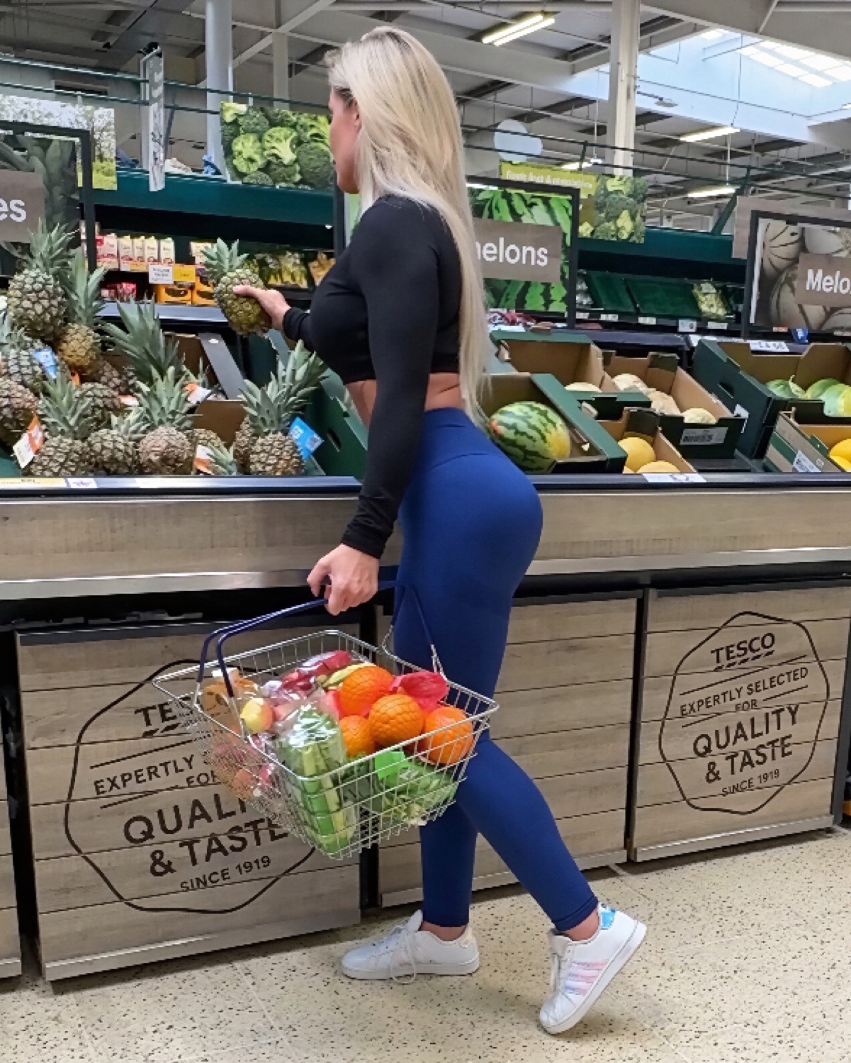 Miss Sally holding her basket full of colourful fresh produce