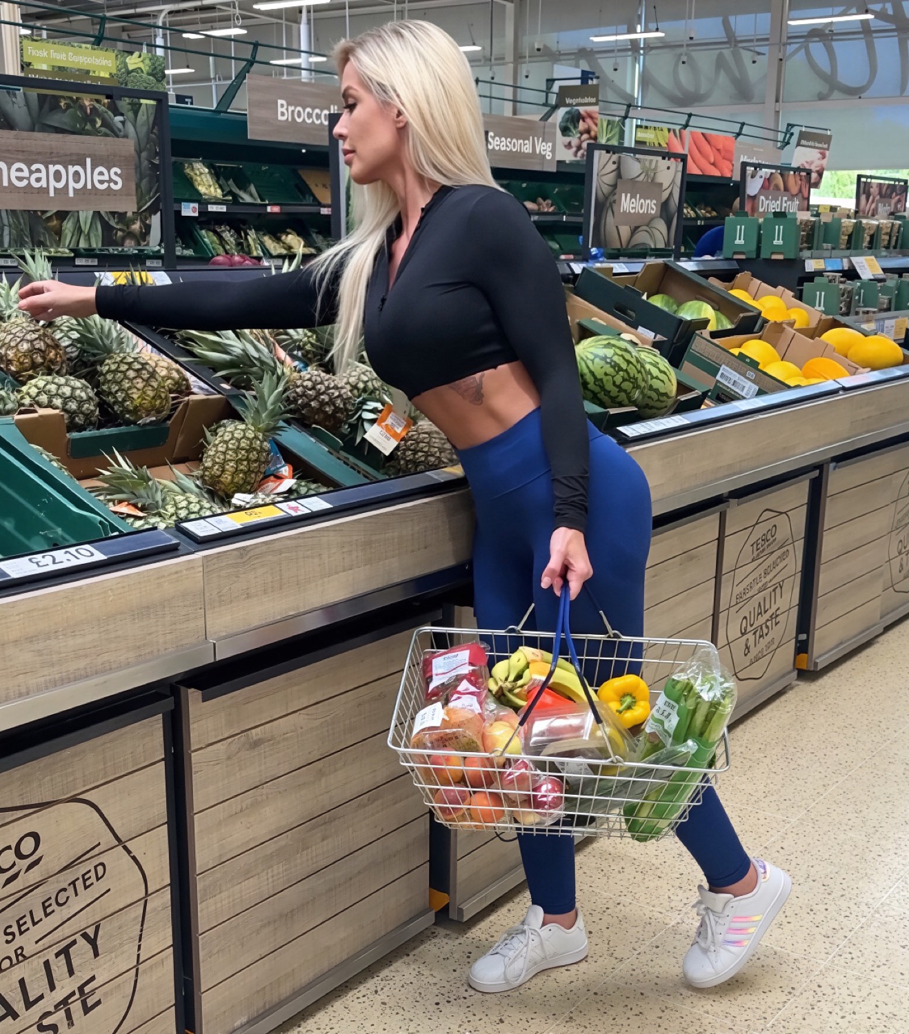 Miss Sally choosing fresh fruit at the market